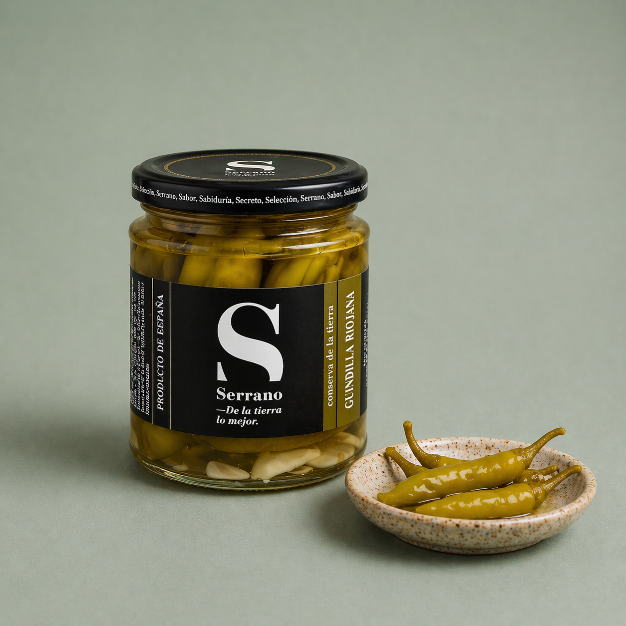 Tarro de guindilla riojana Serrano con guindillas verdes en un plato.