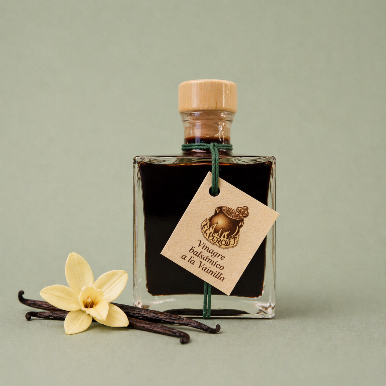Botella de vinagre balsámico a la vainilla El Perolet 10cl con vainas y flor de vainilla sobre fondo neutro.