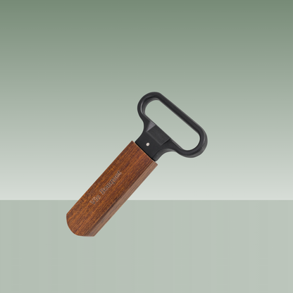 Abridor de botellas Vin Bouquet con mango de madera natural y cabezal metálico negro, diseño ergonómico para abrir chapas, presentado sobre fondo neutro.