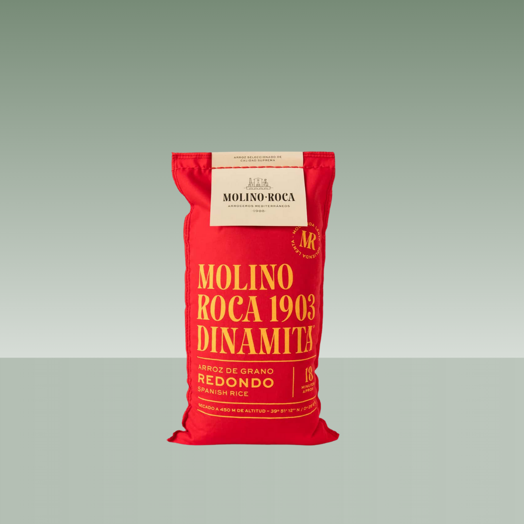Saco de arroz Molino Roca 1903 variedad Dinamita, arroz de grano redondo, en envase textil rojo con tipografía dorada.
