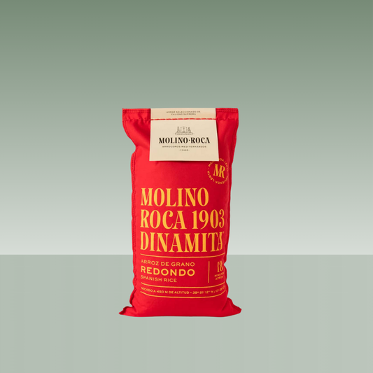 Saco de arroz Molino Roca 1903 variedad Dinamita, arroz de grano redondo, en envase textil rojo con tipografía dorada.