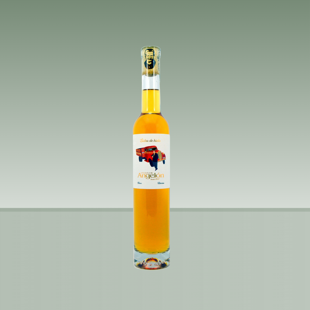 Botella de sidra de hielo Viuda de Angelón, con líquido dorado, botella esbelta de vidrio transparente, cápsula ilustrada y etiqueta blanca con ilustración de camión rojo y figura humana.